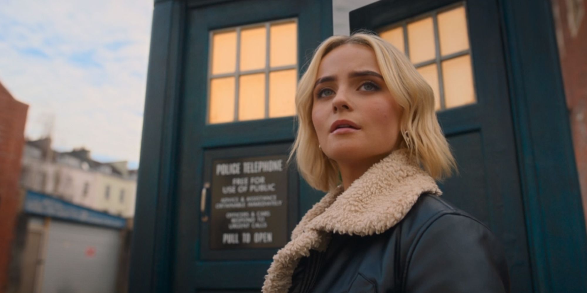 Millie Gibson as Ruby Sunday standing outside the TARDIS in Doctor Who