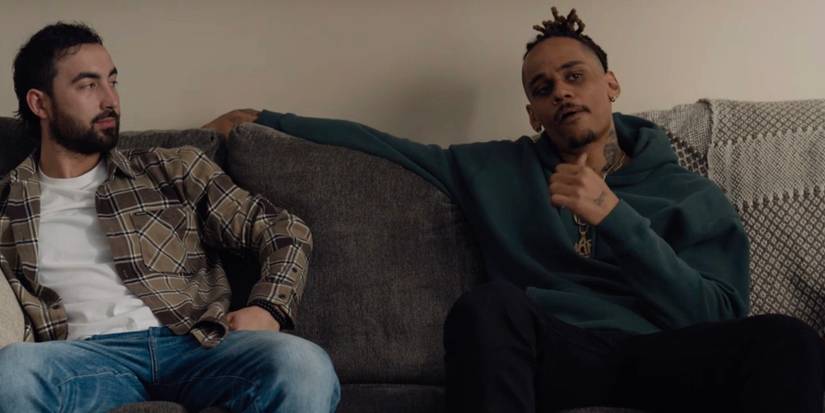 Goody and Dolo sitting next to one another on the couch in Shoresy