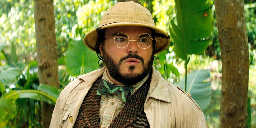 Jack Black in the forest wearing a hat and glasses in Jumanji The Next Level