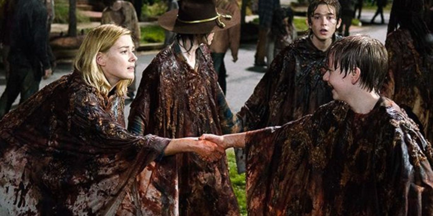 Jessie (Alexandra Breckenridge) holding her son's hand, both covered in blood, in The Walking Dead