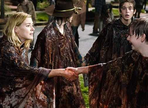 Jessie (Alexandra Breckenridge) holding her son's hand, both covered in blood, in The Walking Dead