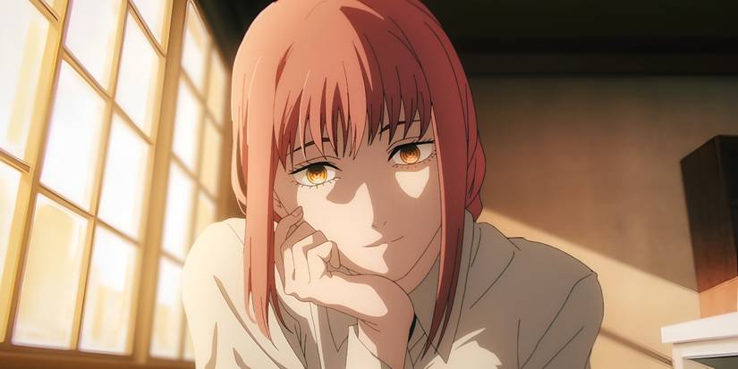 A woman with pink hair and glowing eyes rests her chin on her hands while smiling.