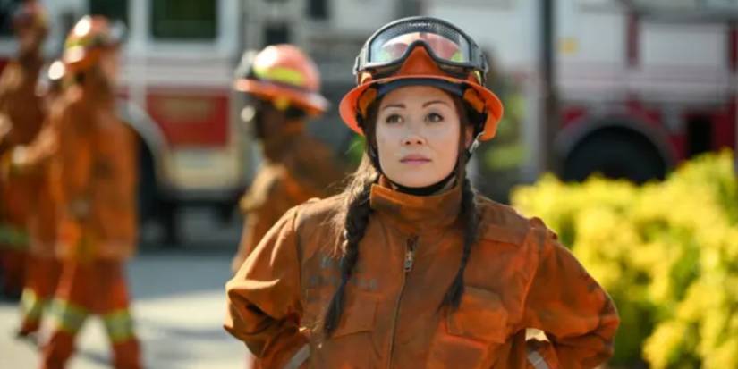 Rebecca Lee (Fiona Rene) in her orange firefighter outfit in Fire Country