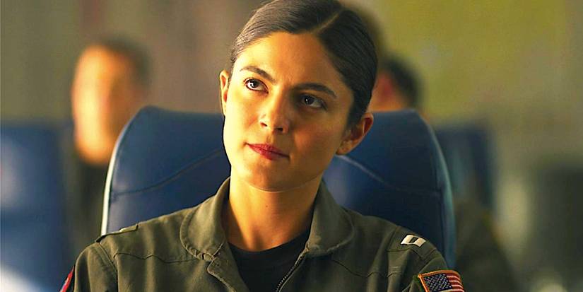 Monica Barbaro as Phoenix sits in a chair staring in Top Gun Maverick