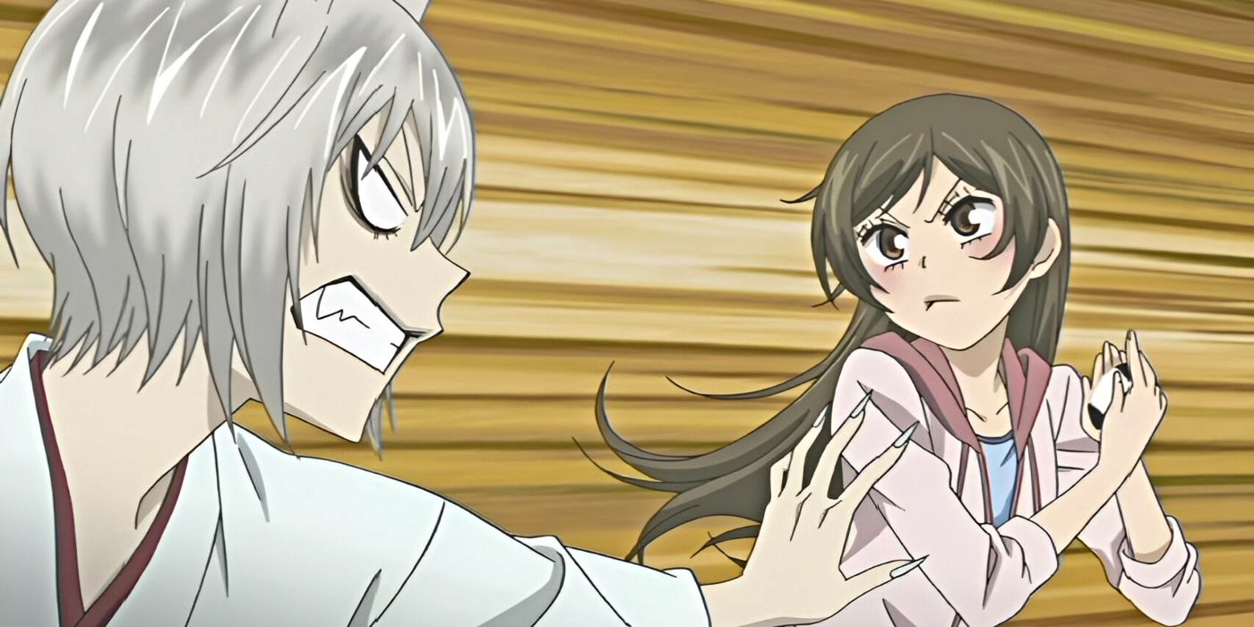 Tomoe angrily reaches for Nanami as she frowns and moves away from Kamisama Kiss.