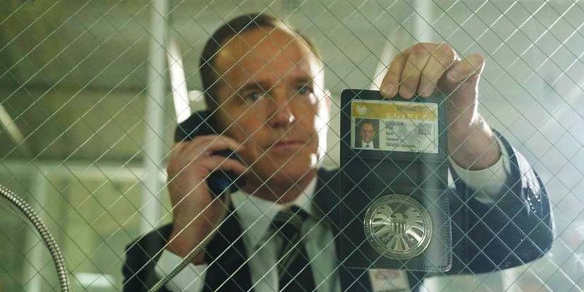 Phil Coulson mostrando seu distintivo da S.H.I.E.L.D. em Agentes da S.H.I.E.L.D.