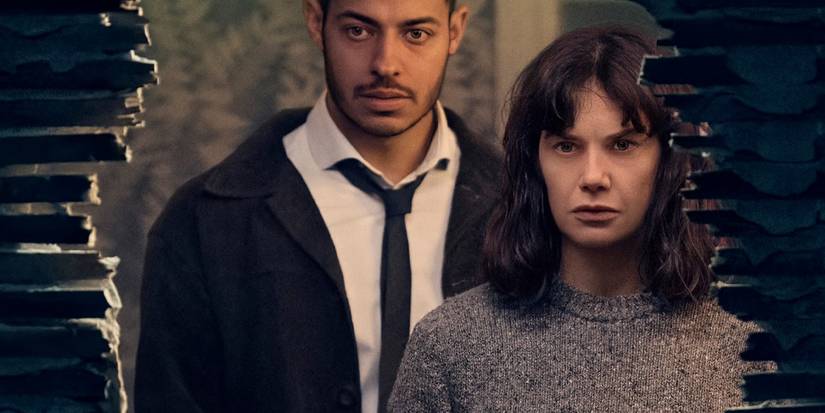 Ruth Wilson in front of a broken wall with Young Colman in The Woman In The Wall
