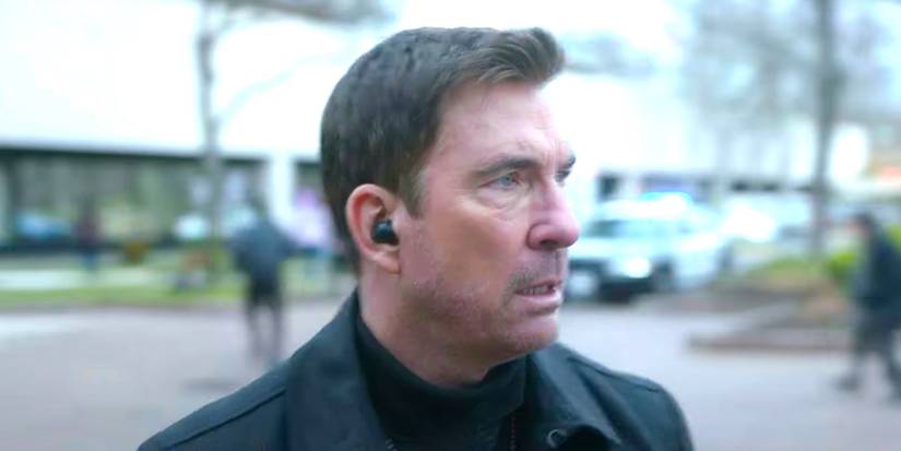 Dylan McDermott as Remy Scott looking worried with a phone receiver in his ear in FBI Most Wanted.