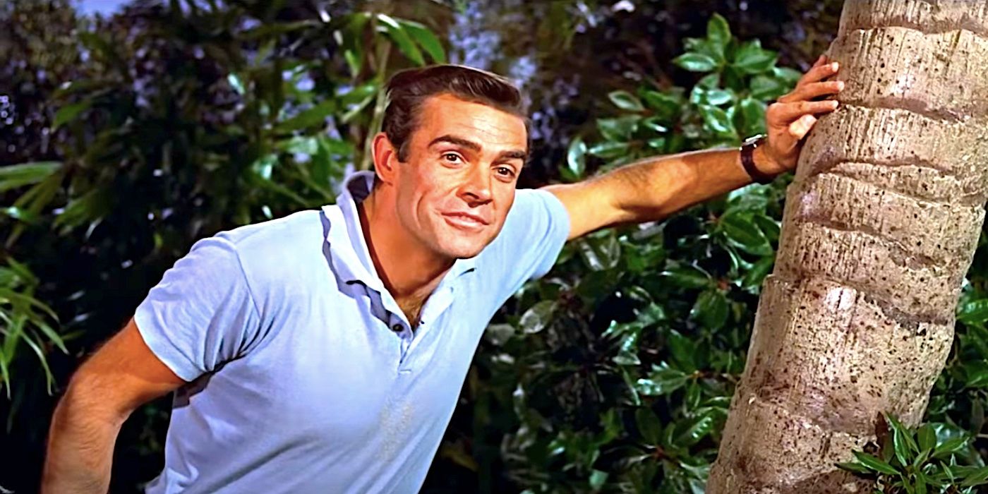 Sean Connery's James Bond leans against a palm tree in Dr. No