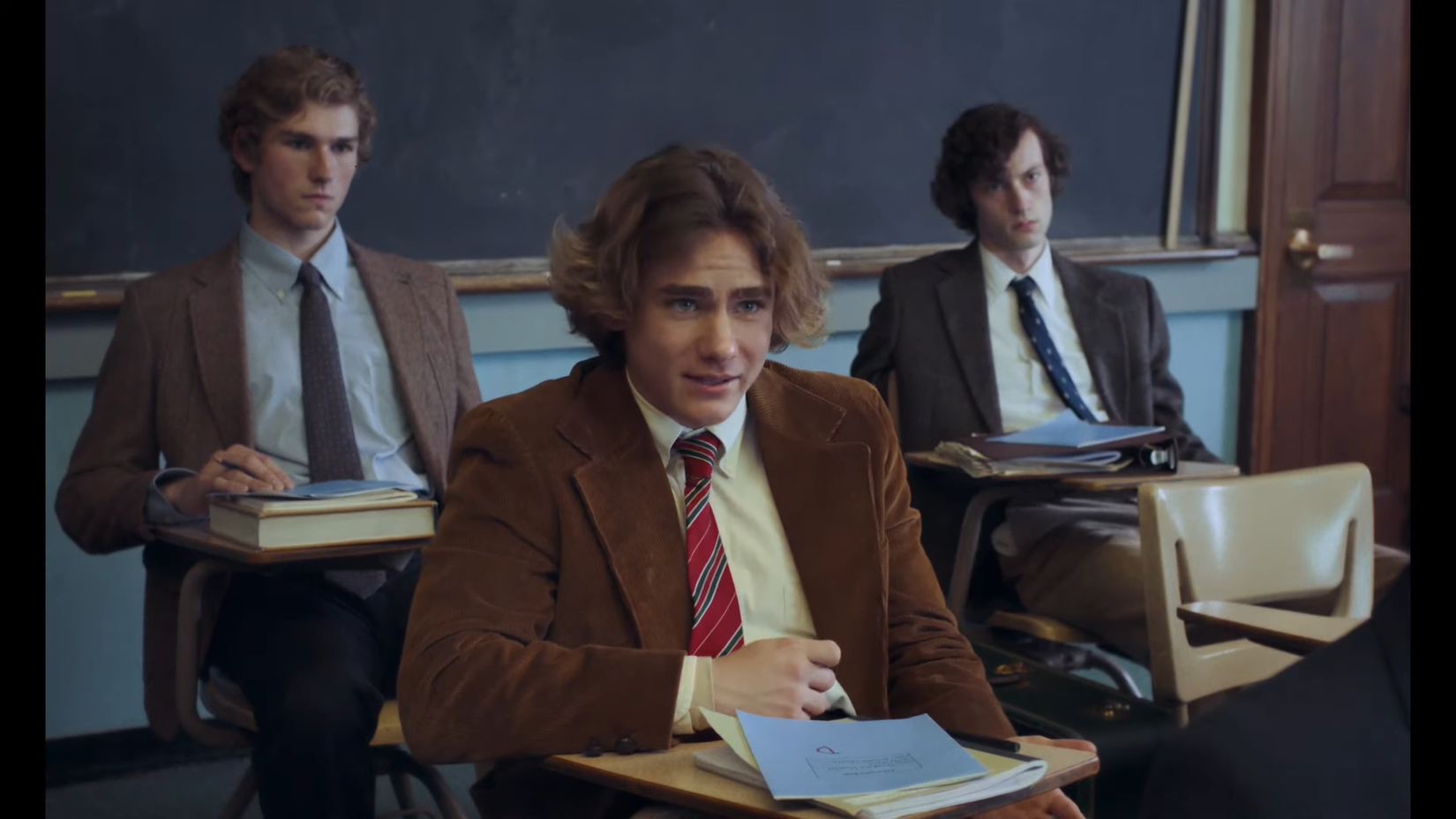 The Holdovers classroom scene with three characters sat at desks