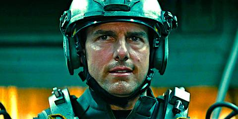 Tom Cruise perspiring while wearing heavy military gear in a scene from Edge of Tomorrow