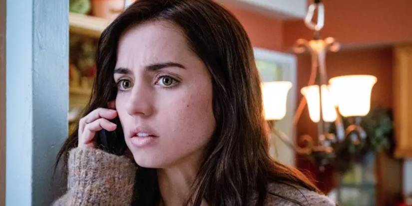 Ana de Armas as Marta looking concerned with a phone held to her ear in Knives Out