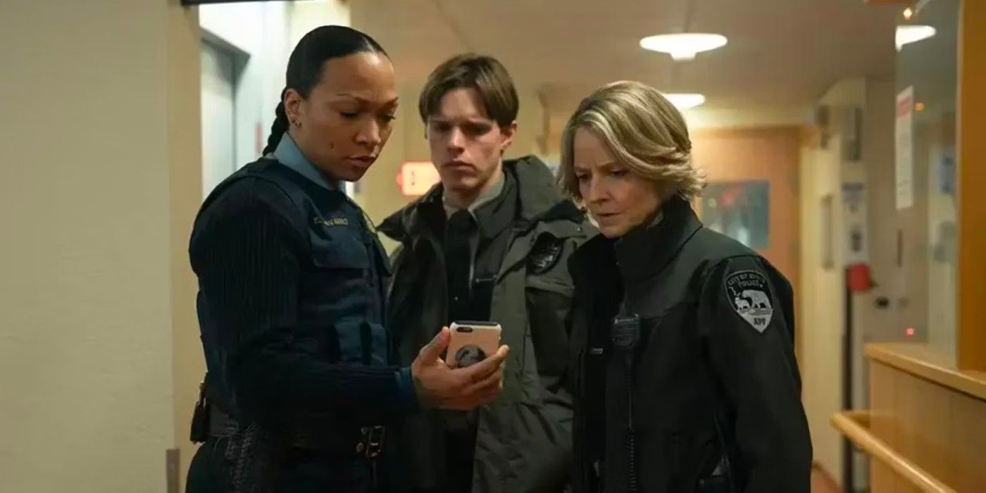 Navarro, Pete, and Danvers looking at a phone in True Detective Night Country episode 3