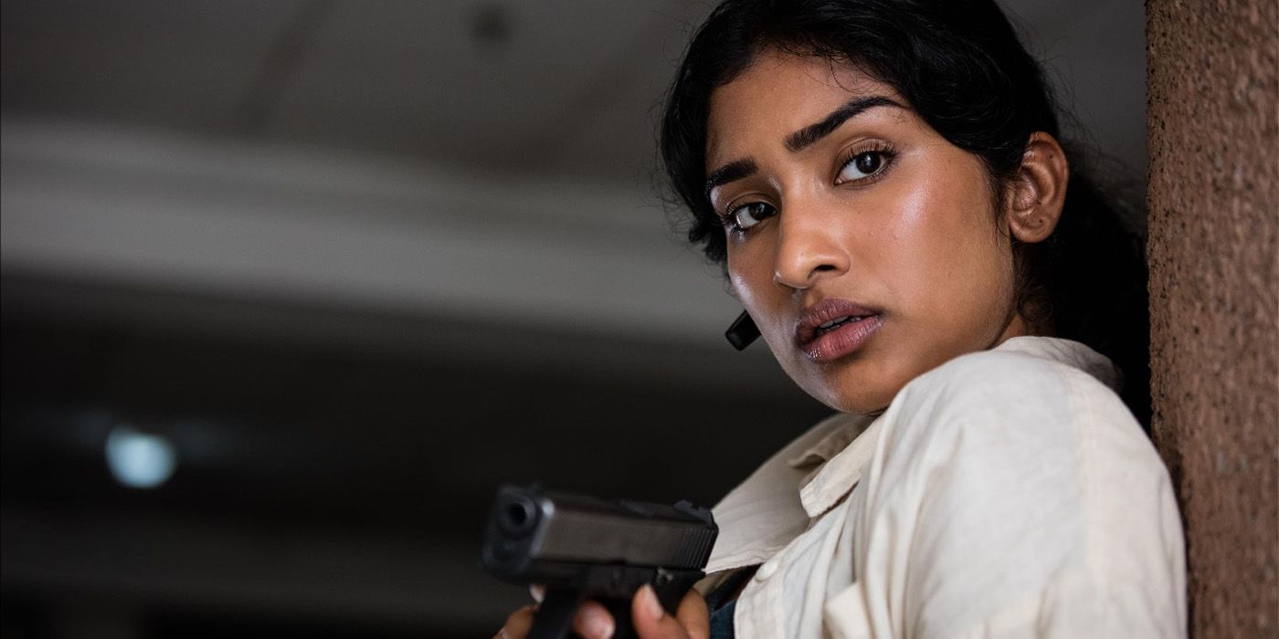 Varada Sethu holding a gun in the movie Strike Back Revolution.