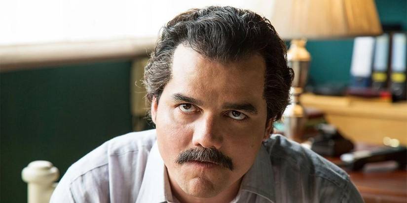 Wagner Moura como Pablo Escobar encara alguém fora de quadro em uma cena de Narcos.