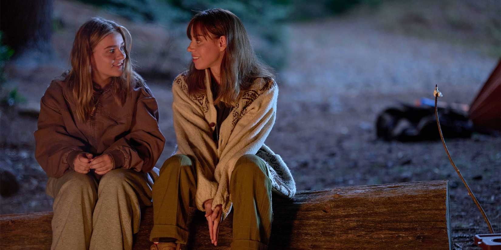 Younger Elliott and older Elliott sit together over a campfire in My Old ᴀss