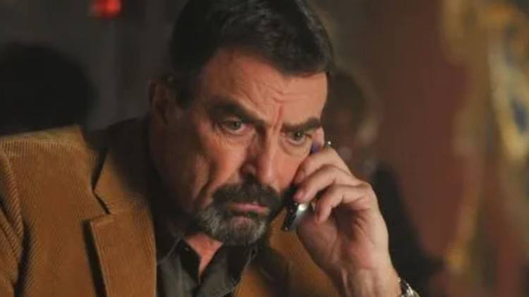 Jesse Stone (Tom Selleck) on the phone looking upset