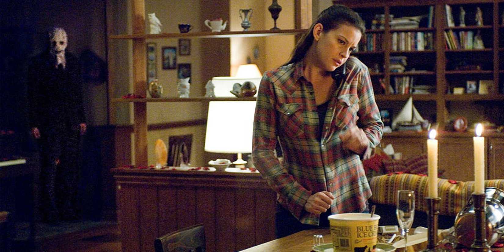 A killer lurks behind Liv Tyler in The Strangers