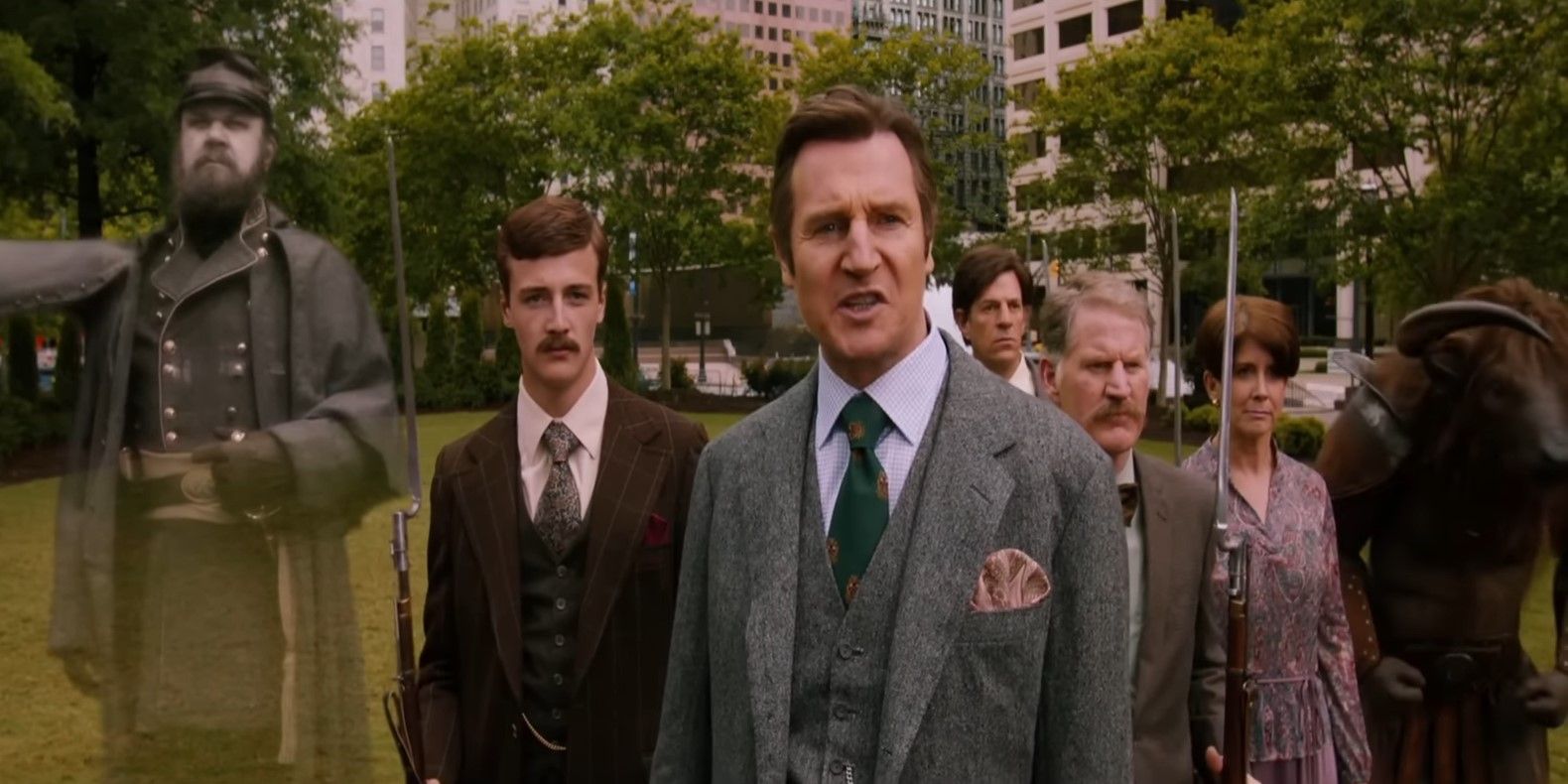 Liam Neeson as the History Channel anchor standing in front of his group of reporters holding muskets, a ghost from the Civil War, and a Minotaur in Anchorman 2