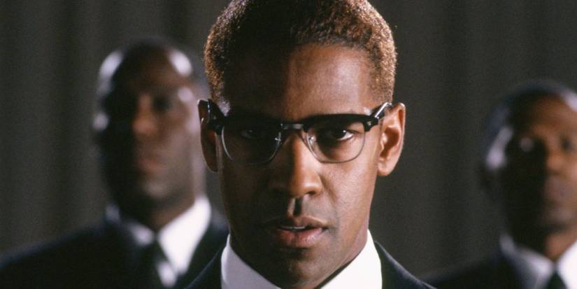 Denzel Washington as Malcolm X stands in front of James McDaniel as Brother Earl and Jean-Claude La Marre as Benjamin 2X in Malcolm X.