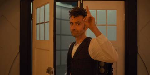 David Tennant as the Fourteenth Doctor saluting as he leaves the TARDIS in Doctor Who.