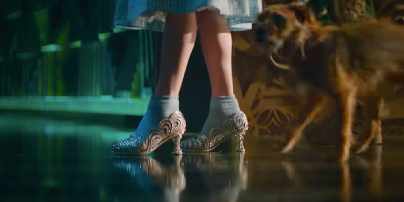 Dorothy wearing silver shoes alongside Toto in Wicked