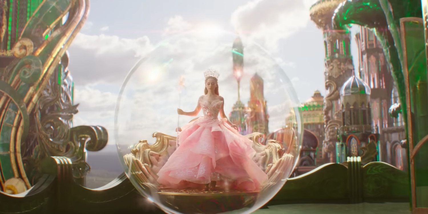 Glinda (Ariana Grande) wears a big pink gown and crown and stands inside a bubble in Wicked.