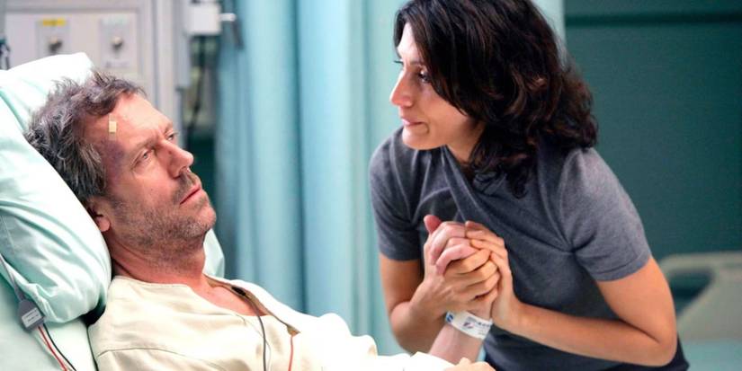 Cuddy comforting an injured House in a hospital bed after the bus crash in the House episode "Wilson's Heart."