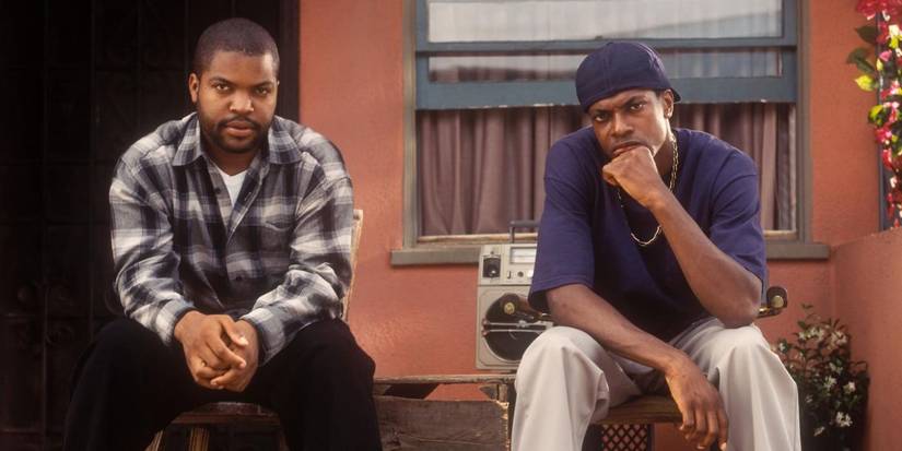 Ice Cube as Craig and Chris Tucker as Smokey sitting in front of the house in Friday.