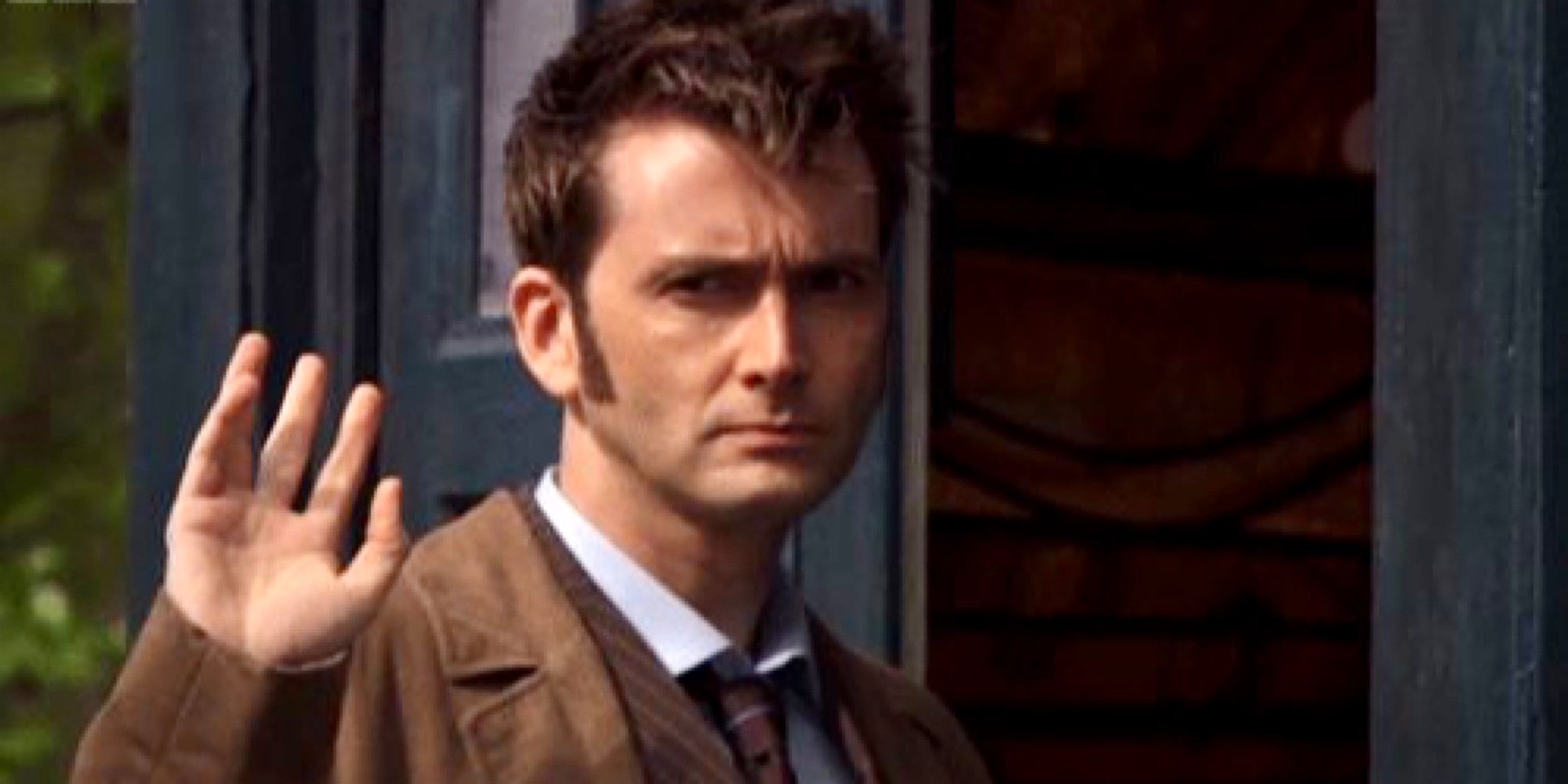 The Tenth Doctor waves goodbye outside of his TARDIS in Doctor Who