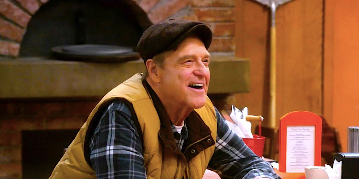 John Goodman's Dan laughing at a diner table in The Conners season 6 episode 1