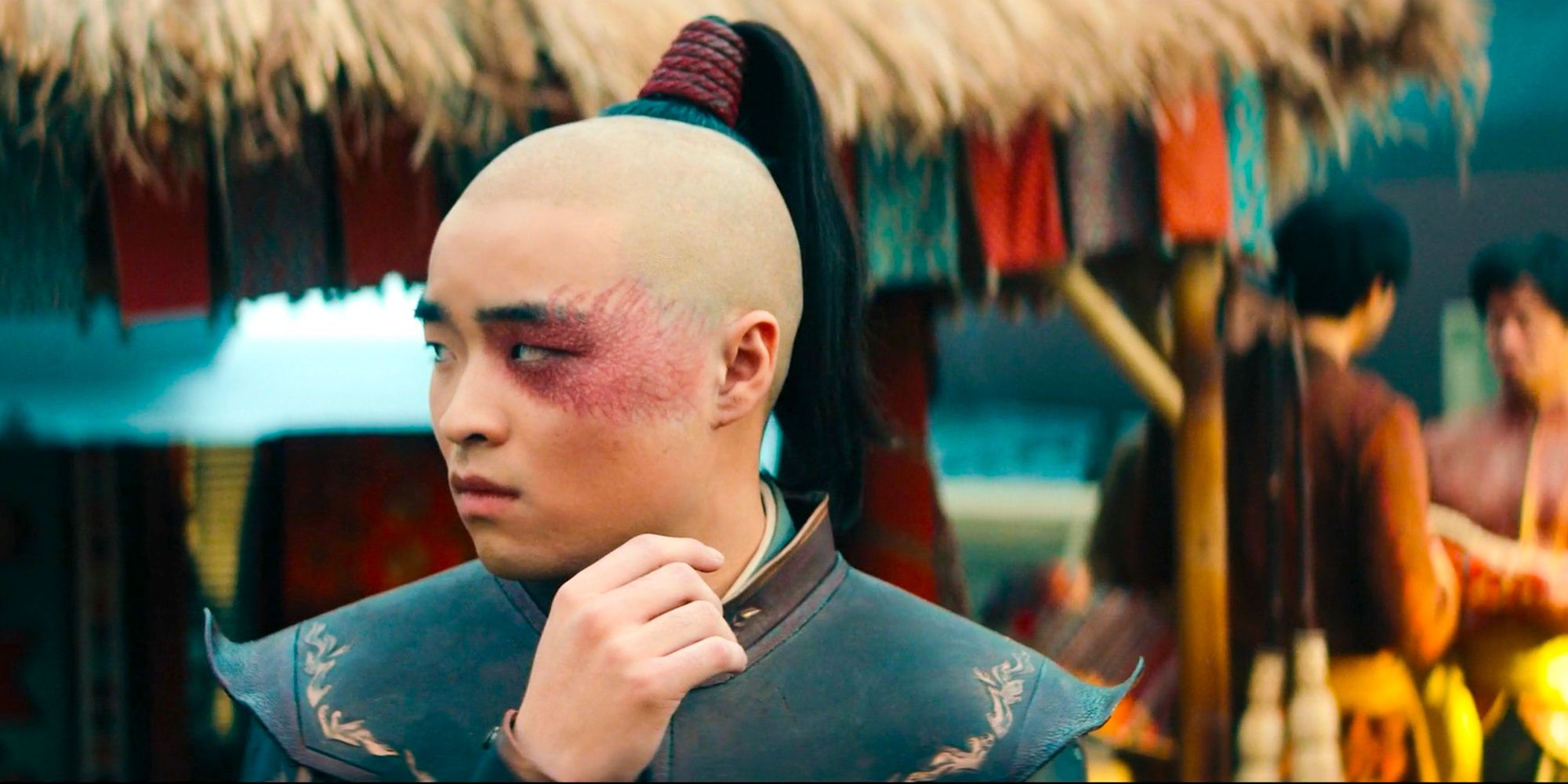 prince zuko from Avatar the last airbender side shot scar with hand up Dallas James Liu as Zuko