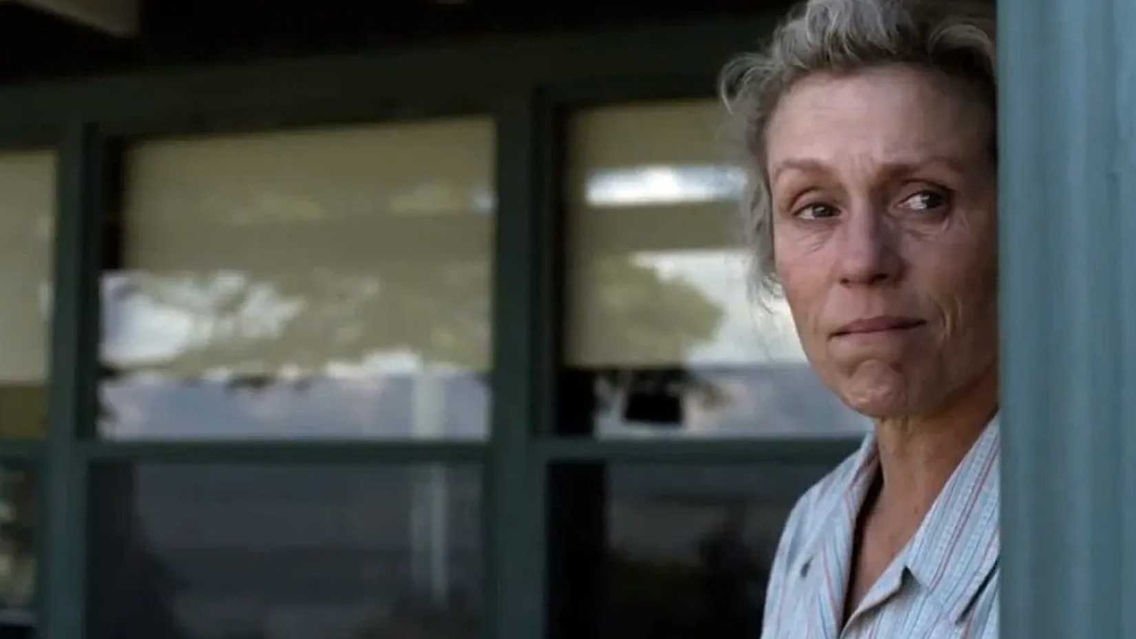 Olive Kitteridge (Frances McDormand) staring out of her house.