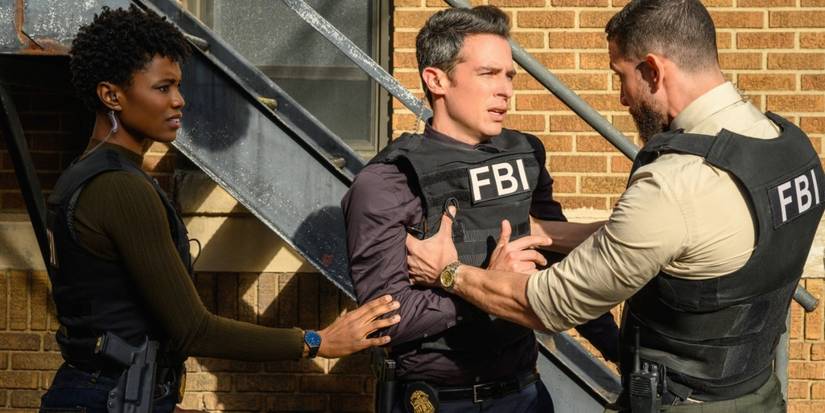 Tiffany and OA grabbing Scola's arm to try to calm him outside a building in FBI