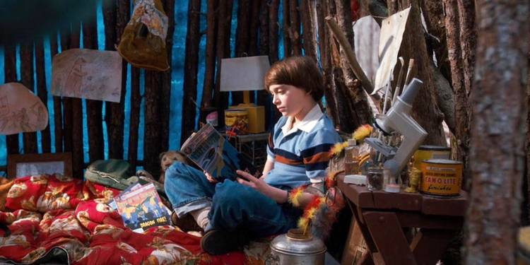 Noah Schnapp's Will reading inside Castle Byers in Stranger Things