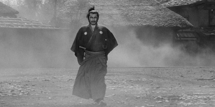Toshiro Mifune as Kuwabatake Sanjuro walking down the road in Yojimbo.
