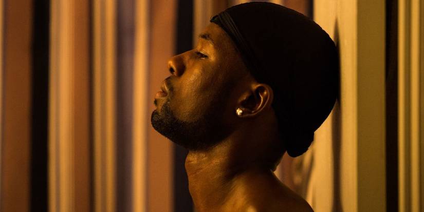 trevante rhodes as chiron black solemnly looks off into the distance in moonlight
