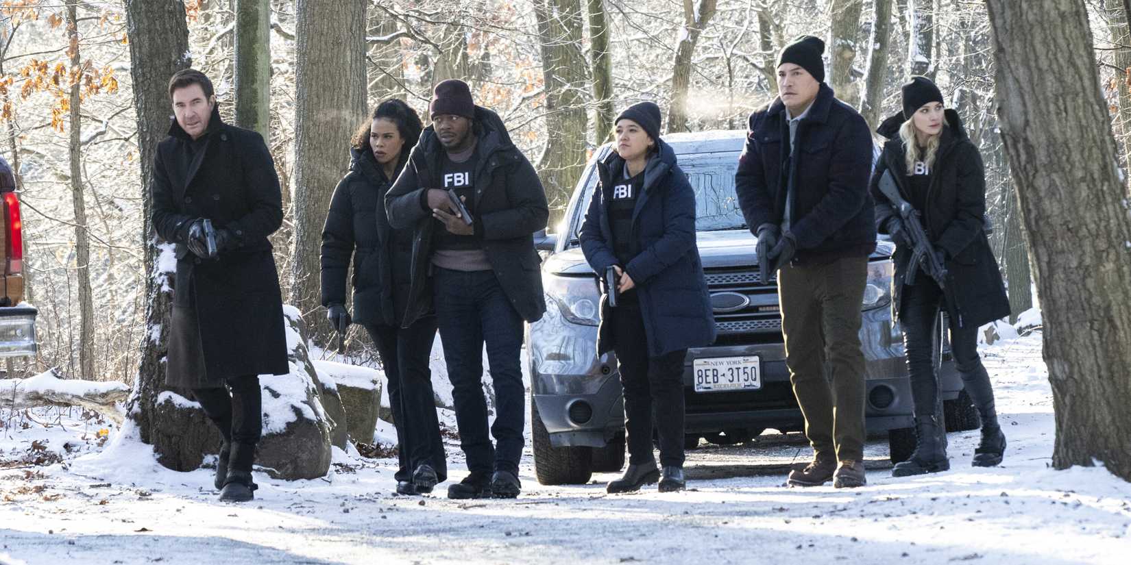 FBI:Most Wanted Remy and his team standing in front of a car in snowy woods with guns drawn