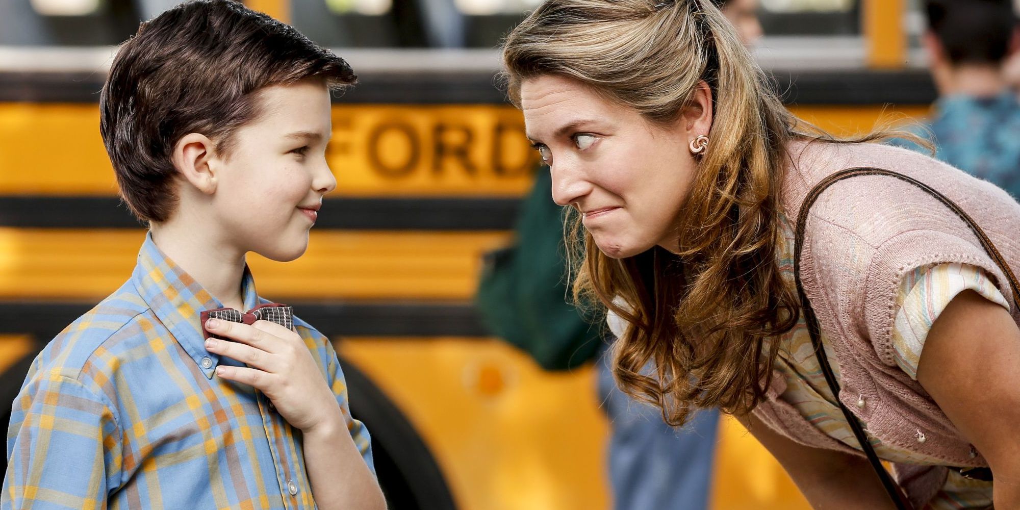 Mary bending down to talk to Sheldon at school in Young Sheldon