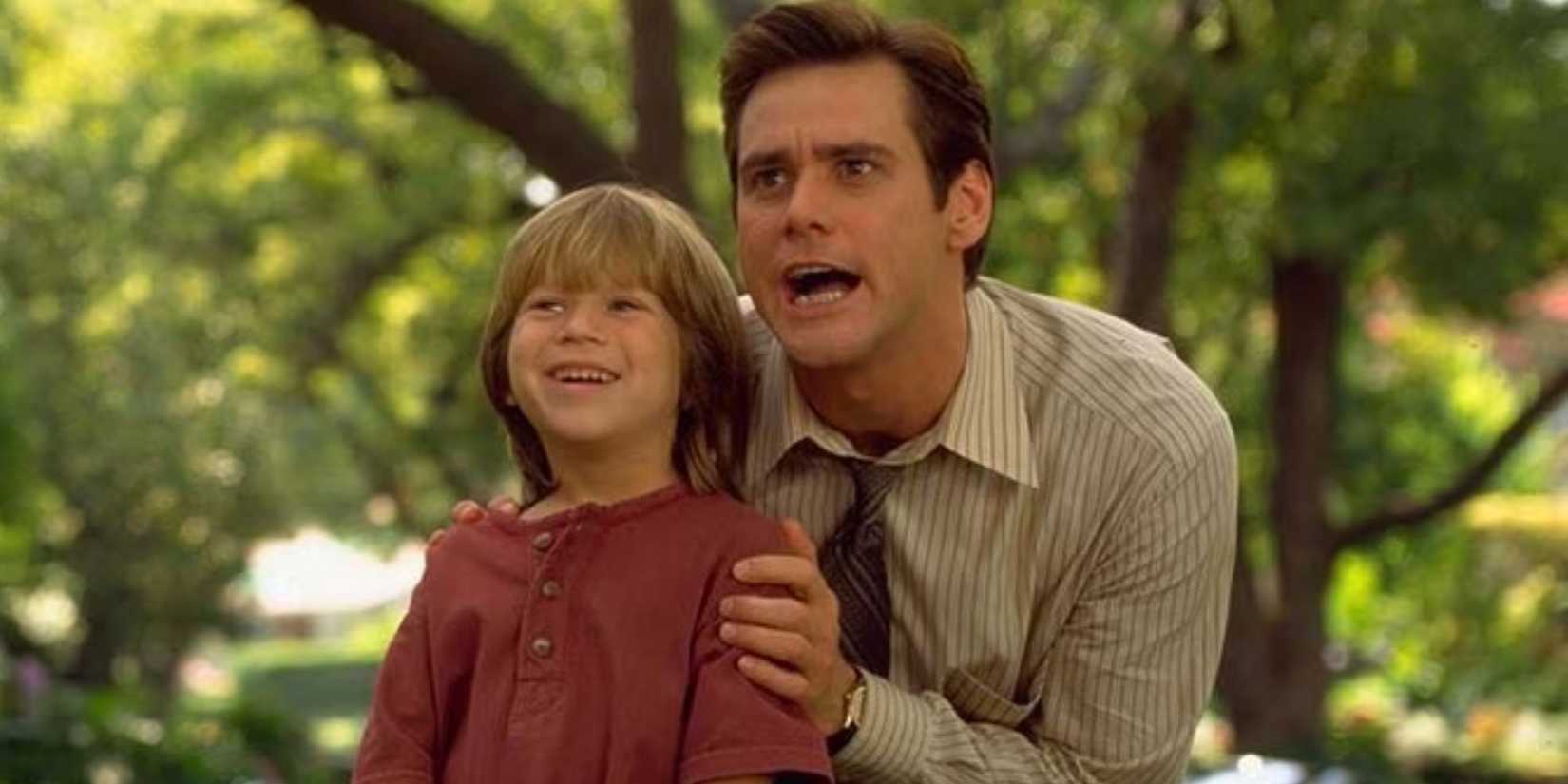 Jim Carrey as Fletcher Reede holding Justin Cooper as Max Reede by the shoulders in Liar Liar