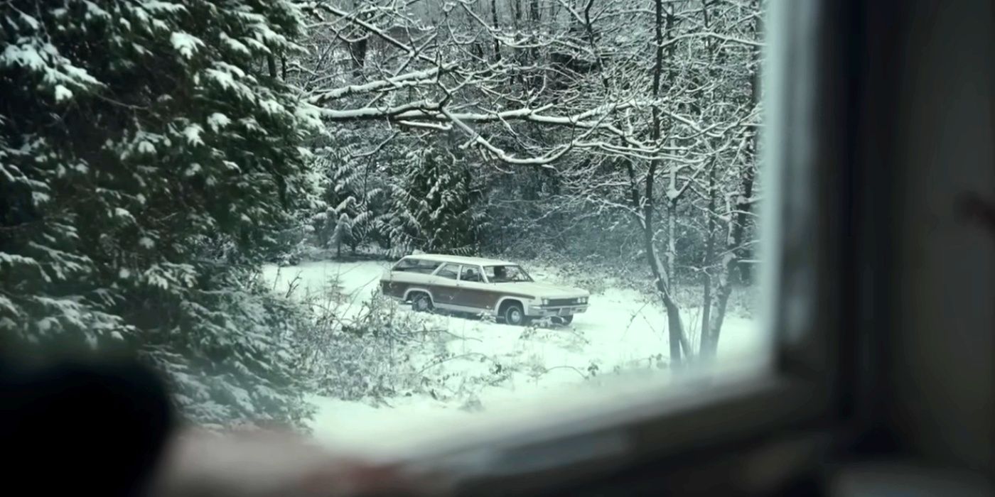 A station wagon in the snow in Longlegs trailer.