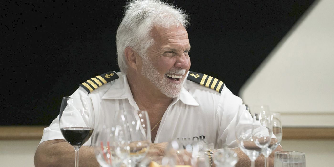 Captain Lee Rosbach Below Deck Laughing wearing uniform and laughing at dinner