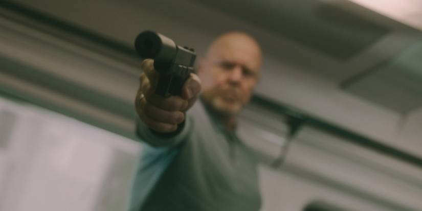 Chernitsky in Slow Horses holding a gun