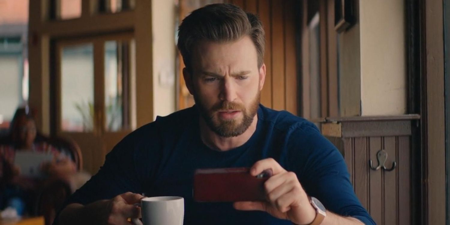 Chris Evans as himself looking at a phone in Free Guy