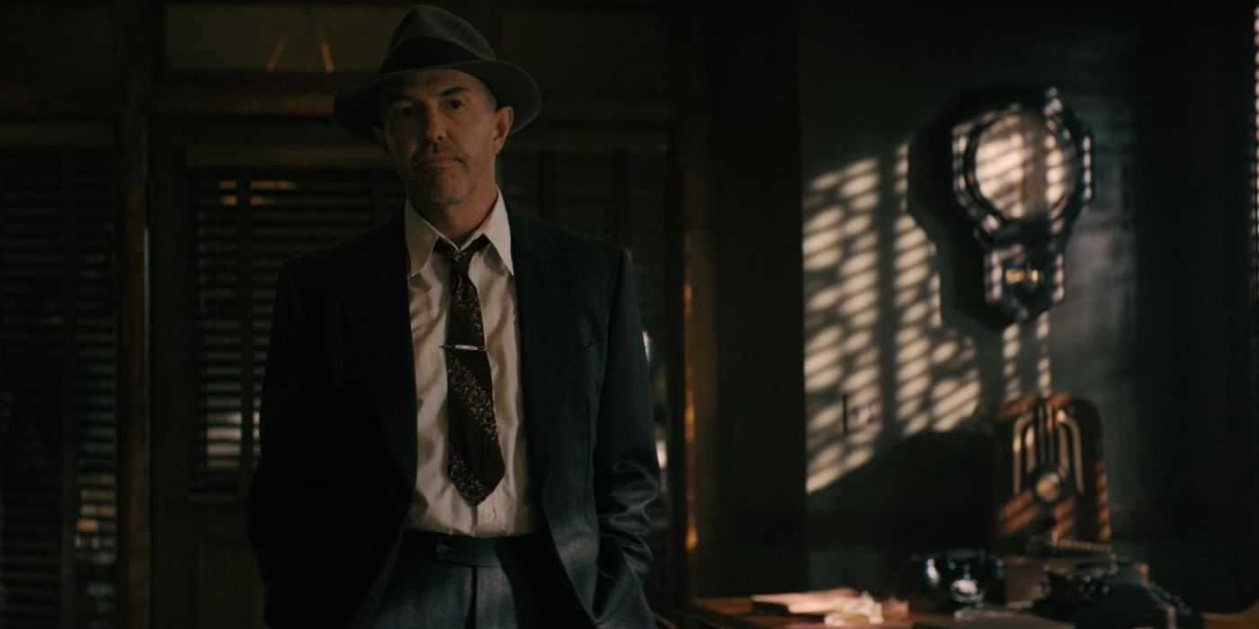 Detective Holcomb (Eric Lange) standing in Mason's office in Perry Mason season 2, episode 6.