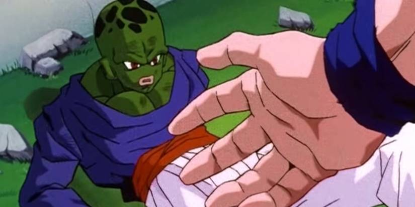 Screenshot from Dragon Ball Z anime Other World Tournament shows Pikkon on the ground with Goku extending his hand out to him.