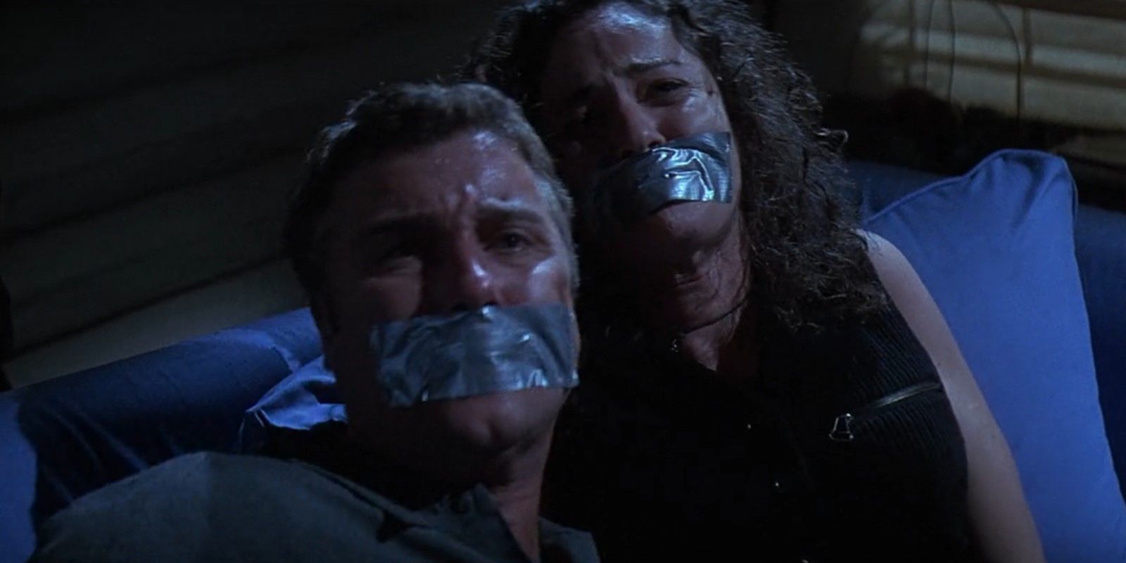 Steve (William Petersen) and Laura (Amy Brenneman) with duct tape over their mouths in Fear