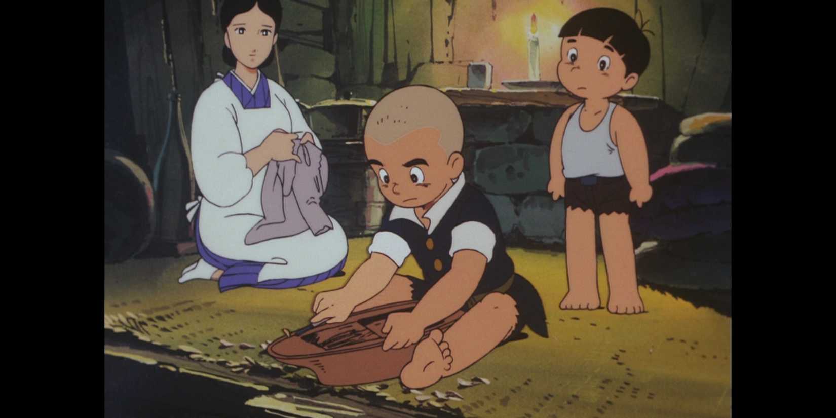 Bild aus dem Animationsfilm „Barefoot Gen“: Gen übersieht einen hölzernen Gegenstand, während seine Mutter Kleidung flickt, und ein anderes Kind übersieht Gen. Alle drei sind in einer Hütte.