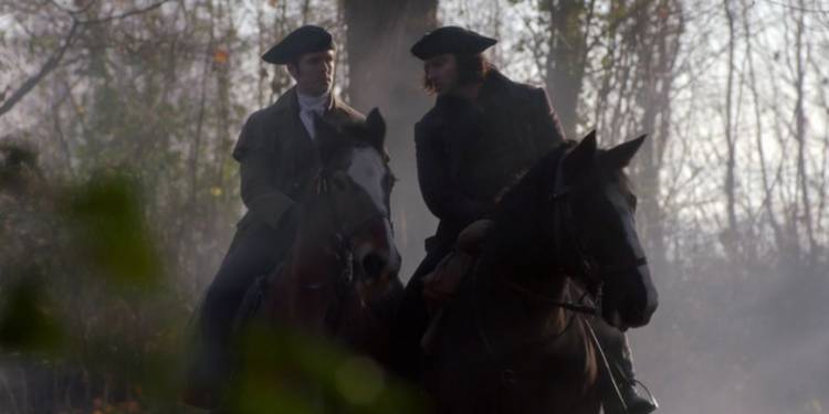 George (Jack Farthing) and Ross (Aidan Turner) on horses in Poldark