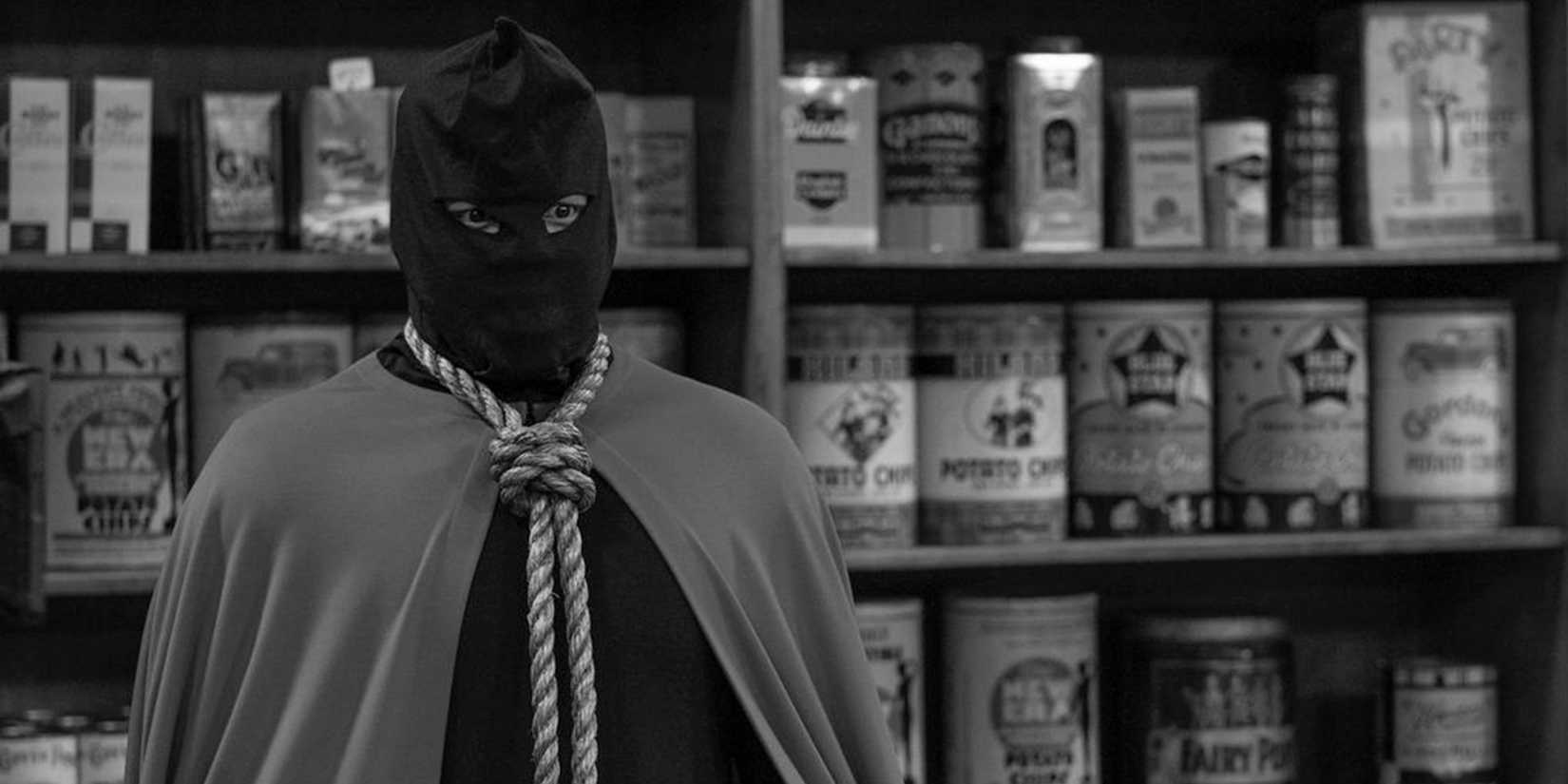 Hooded Justice (Jovan Adepo) in black-and-white in Watchmen
